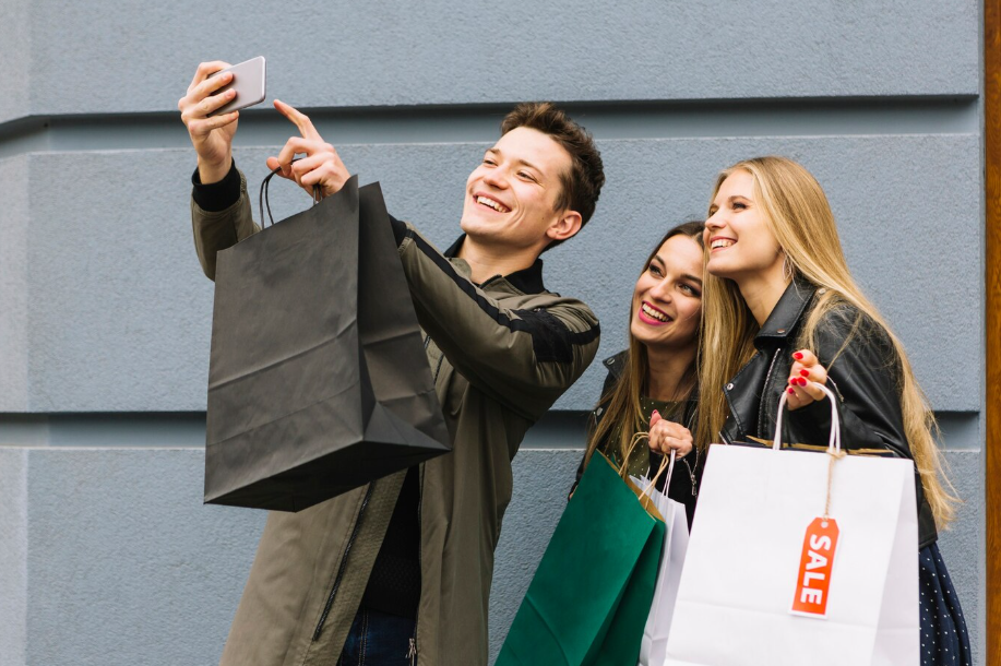 Friends shopping during seasonal sales, understanding what to buy now vs later for better deals