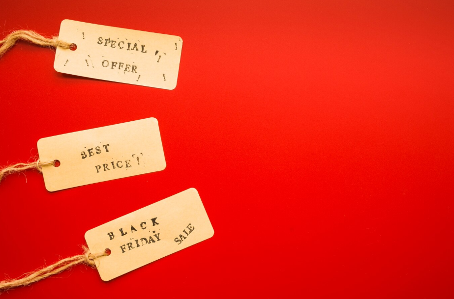 Paper price tags on a red background labeled "Special Offer," "Best Price," and "Black Friday Sale"